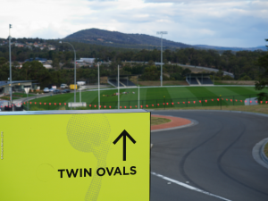 Twin Ovals viewed from the road with sign in foreground